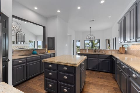 Chef's kitchen with all the essentials, a large island, and plenty of counter space for easy meal prep.