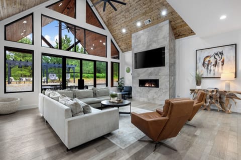 Living Room: Sun-soaked space with stunning views, sleek decor, and a cozy fireplace for gatherings!
