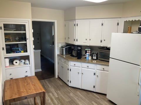 Regular coffee maker, toaster/air fryer, prep/table with wings, pots, pans, etc.