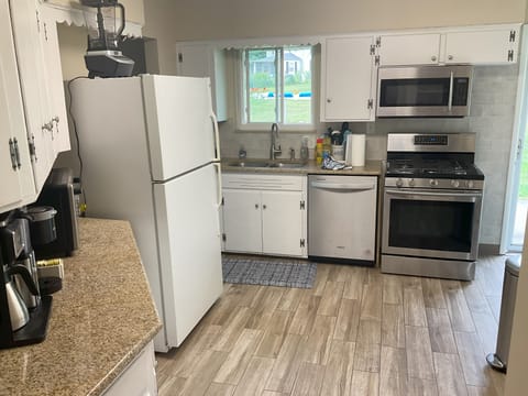 Well-outfitted kitchen: utensils, ice maker, gas stove, blender, mixer, Keurig.