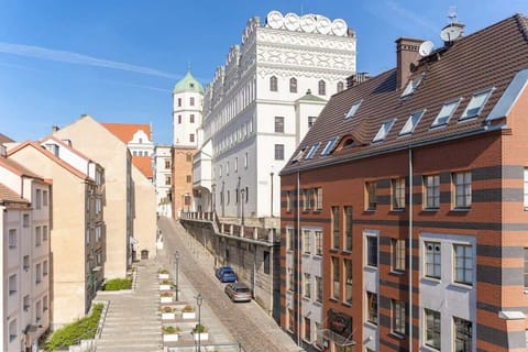 Street view of city with historic buildings and a church tower.