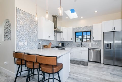 Kitchen features, microwave, oven, dishwasher, stovetop, refrigerator with sky light for natural light