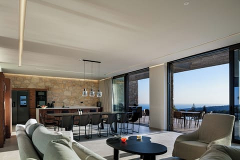 Open plan living and kitchen area, with direct access to the pool area