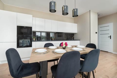 Fully equipped kitchenette with kitchen appliances and dining area.