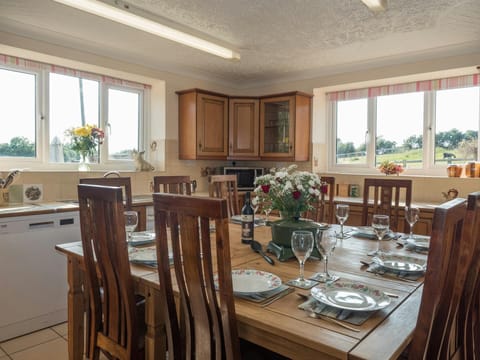 Fitted kitchen / Dining room in Oaktree Cottage, table and 10 chairs, fitted units and windows