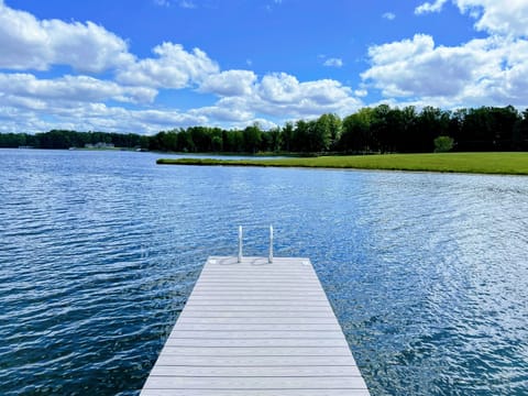 Peaceful dock extending into a clear, tranquil lake, perfect for a serene retreat
