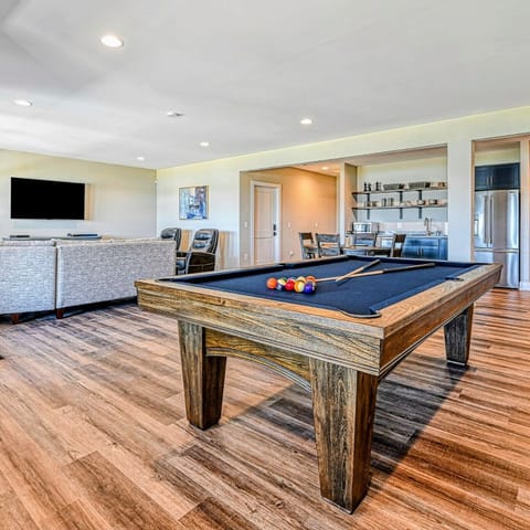 Stylish open-concept living space with a pool table and modern amenities, perfect for entertainment and relaxation