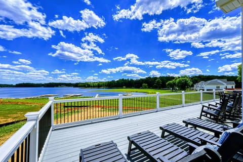 Spacious deck with comfortable seating and stunning panoramic lake views, perfect for relaxing outdoors