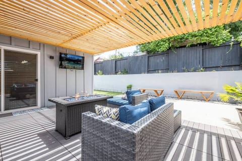 Outdoor living space with TV, fire pit, dining area, grill and outdoor games