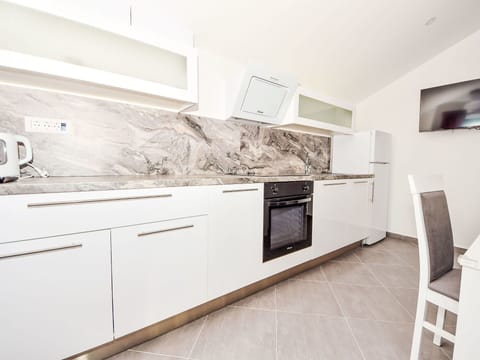 Cabinetry, Countertop, Kitchen, Wood, Kitchen Stove, Kitchen Appliance, Flooring, Floor, Building