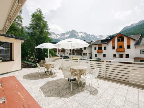 Sky, Cloud, Furniture, Property, Building, Table, Window, Flowerpot, Outdoor Furniture, Umbrella
