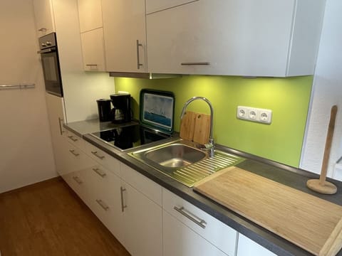 Tap, Cabinetry, Kitchen Sink, Countertop, Sink, Plumbing Fixture, Kitchen Appliance, Kitchen Stove, Lighting, Kitchen