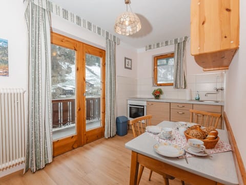 Table, Property, Furniture, Cabinetry, Wood, Interior Design, Lighting, Orange, Living Room, Kitchen