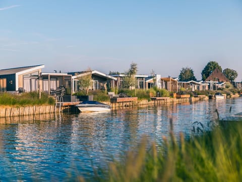 Water, Sky, Plant, Water Resources, Building, Cloud, Natural Landscape, Tree, Lake, Boat