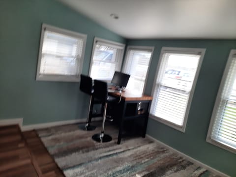 Work area with monitor, keyboard, and mouse with great view of lake.
