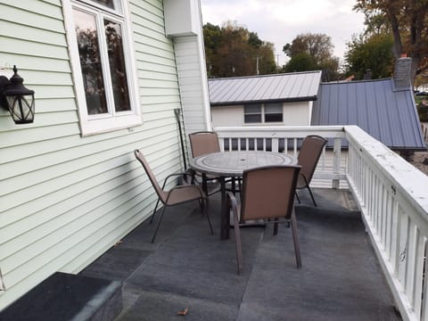2nd floor balcony with patio table, chairs, and umbrella
