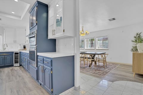 Kitchen fully equipped with lots of dishes, glassware, wine glasses, flatware and kitchen utensils