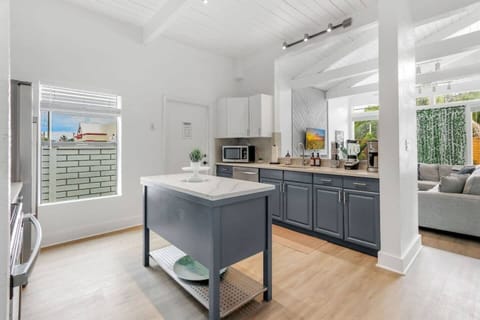 sleek stainless steel appliances and a spacious island, perfect for meal prep, dining, and entertaining in this modern kitchen.