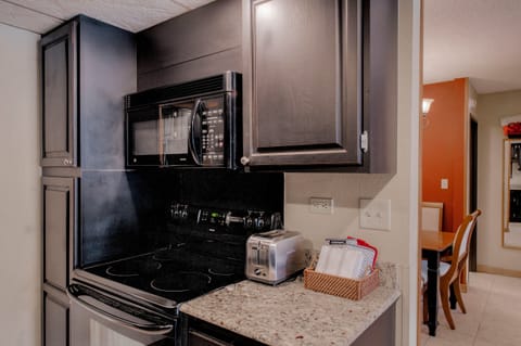 Kitchen with drip coffee pot, electric stovetop, toaster and more