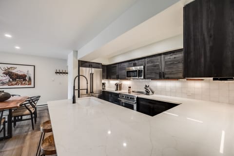 The chic, modern kitchen offers ample space & all the comforts of home