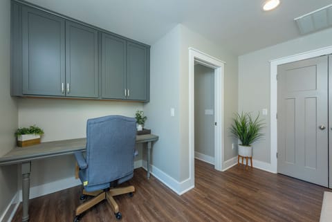 Upper-level landing with designated work space and desk chair.