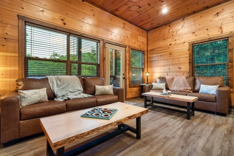 Rustic cabin with cozy sofas—unwind after a day in the Smoky Mountains.