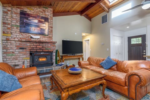 Cozy and spacious living area with TV & wood burning fireplace