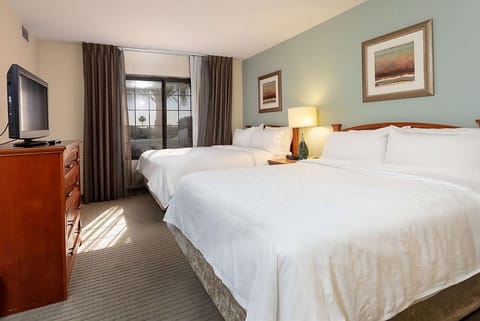 Stretch out on two plush beds in sunlit comfort.