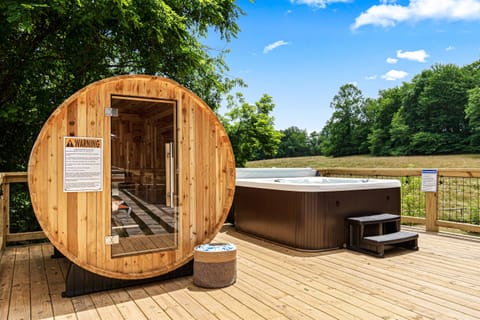 Your own spa retreat: hot tub, sauna, and a front-row seat to calming countryside views.