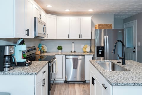 Stylish and functional, with modern appliances including a microwave and dishwasher.