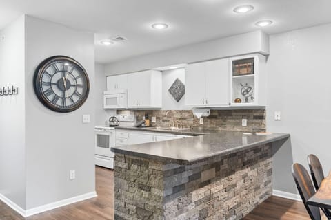 The airy, open kitchen is fully equipped with all the comforts of home