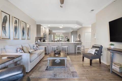 Open living space with Smart TV, sofa sleeper, balcony & sunroom access