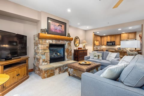 Cozy up by your stone fireplace while dinner simmers in the full kitchen—this inviting space blends rustic warmth with modern comfort.