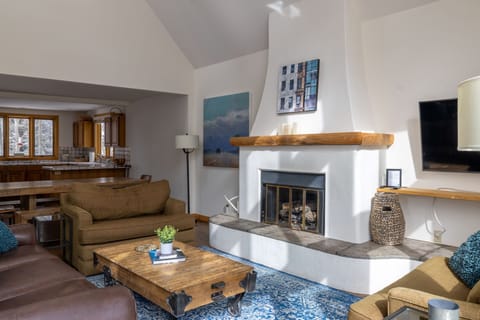 Living room with vaulted ceilings and access to BBQ on deck