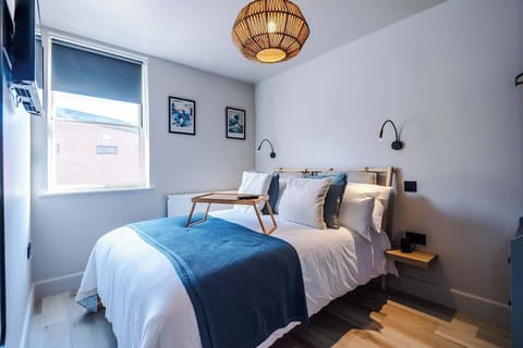 Large double bed with reading lights on either side of the bed