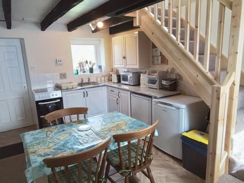 Dining and kitchen area with dining table and chairs
