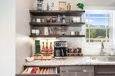 Our luxury house offers premium coffee makers, including French Press, Nespresso, and drip, with perfectly stocked supplies and modern appliances on open shelving. Whether you crave a quick espresso or a rich, slow brew, weâve got your perfect cup covered.