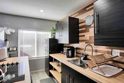 Apt's 3 Kitchen: Modern design meets functionality with sleek appliances and ample natural light!