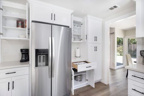The kitchen is well stocked with cookware, utensils, silverware, and glassware. 