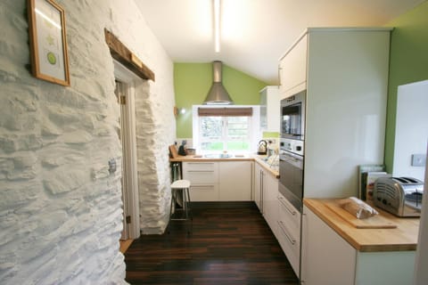Long narrow kitchen with eye level oven, hob and sink under the window
