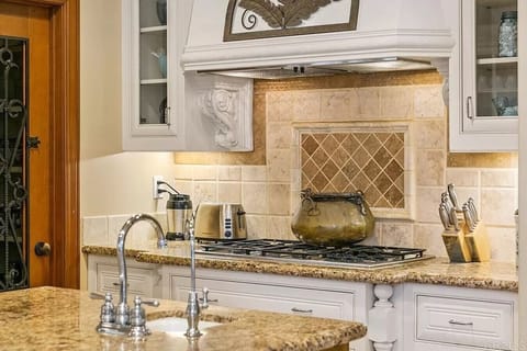 The kitchen offers a stove, toaster, and other essential cooking appliances for your stay.