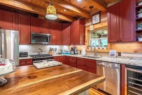 Fully equipped kitchen with granite, cherry wood accents & stainless appliances