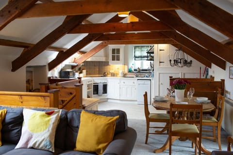 living room leading to kitchen diner area with 3 seater sofa with bright coloured cushions