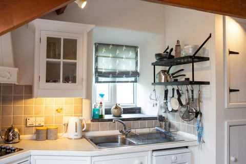 Kitchen with dishwasher and plenty of cooking utensils