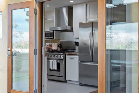 Kitchen opens to large deck and outdoor dining area.