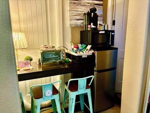 Kitchenette with many amenities cups plates silverware, Keruig coffee machine 