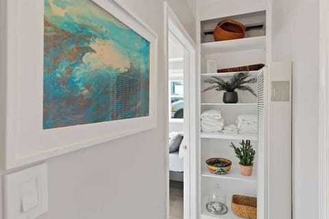 The small hallway from the living room to the primary bedroom. Bath and beach towels provided for your convenience!