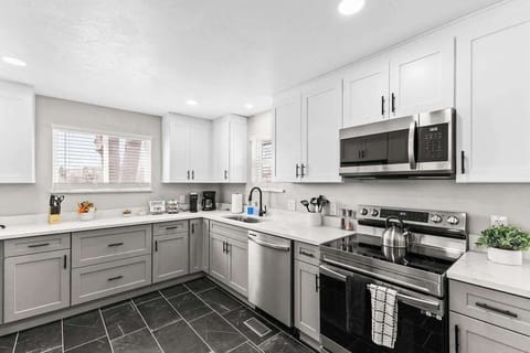 The kitchen is fully updated with stainless steel appliances and cooking items.
