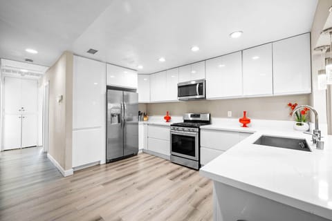 Cook like a pro in this modern kitchen, fully equipped with stainless steel appliances, sleek countertops, and ample storage.