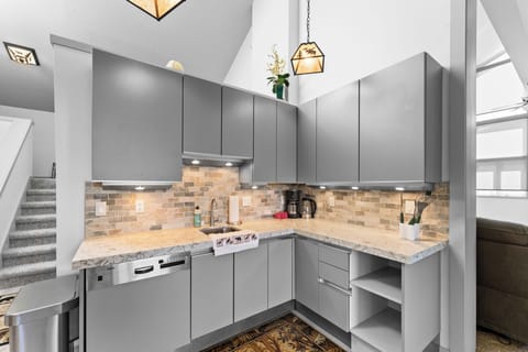 Kitchenette with dishwasher, adjacent to main kitchen.